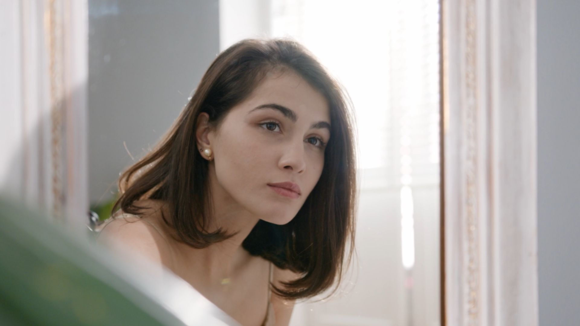 Image of a woman looking at the mirror